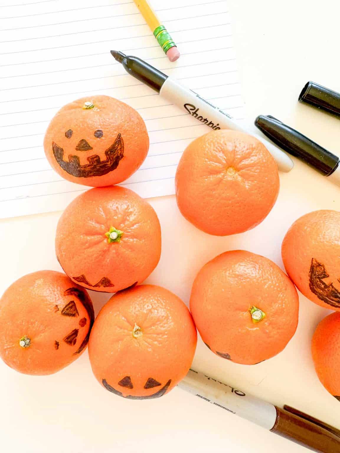 Clementine pumpkins, sharpies and a pencil.