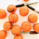 Clementine pumpkins, sharpies and a pencil.