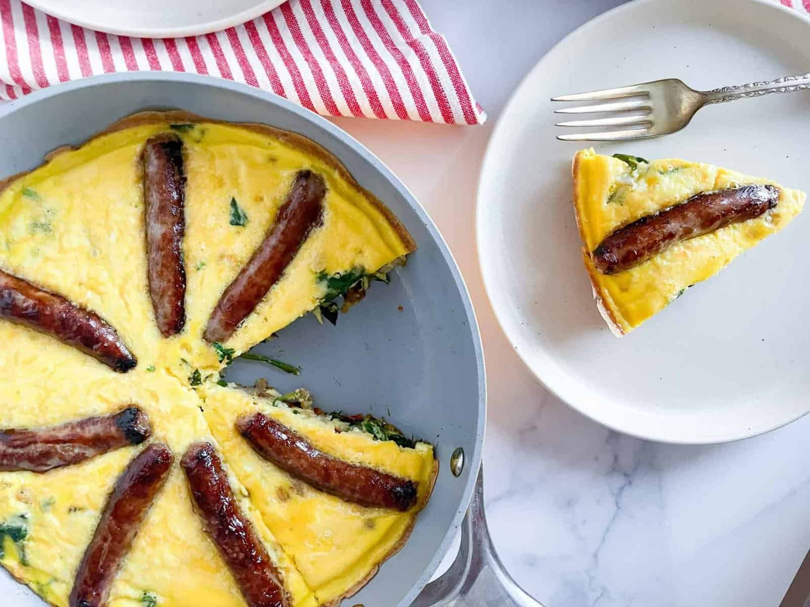 Eggs and sausage in a frying pan.