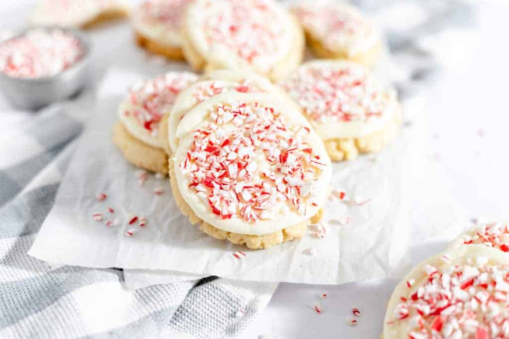 Peppermint candy cane cookies topped with peppermint frosting and crushed candy canes.