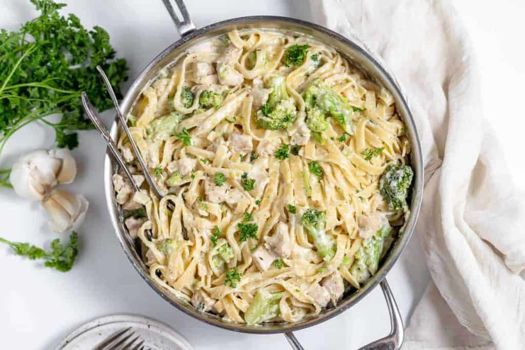 Chicken broccoli Alfredo in a skillet.