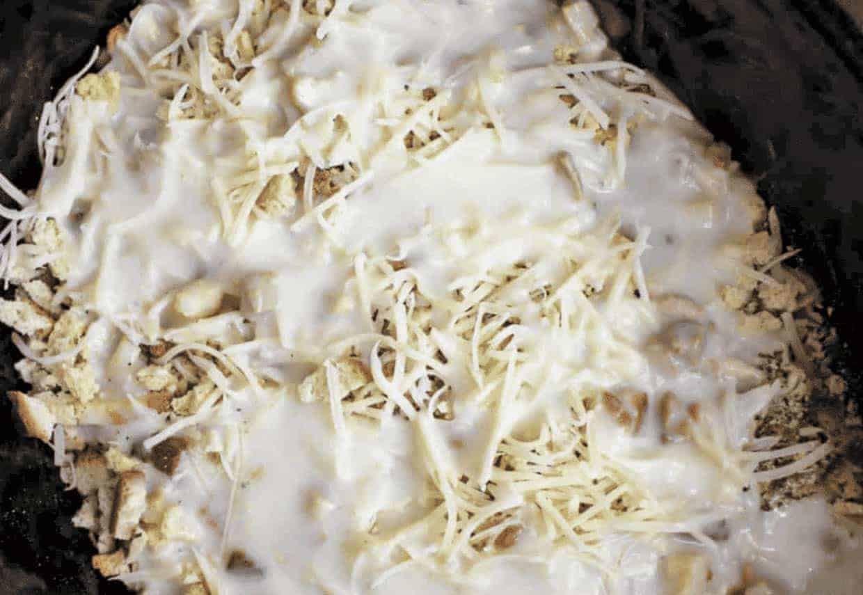 A close up of cheese and cream soup in a crock. 