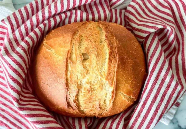 Bread in a striped towel.