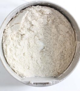 Close-up of ground rice in a grinder, with a fine, powdery texture.