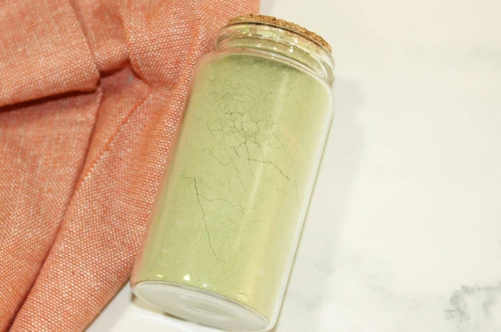 Jar filled with green tea cleansing grains.