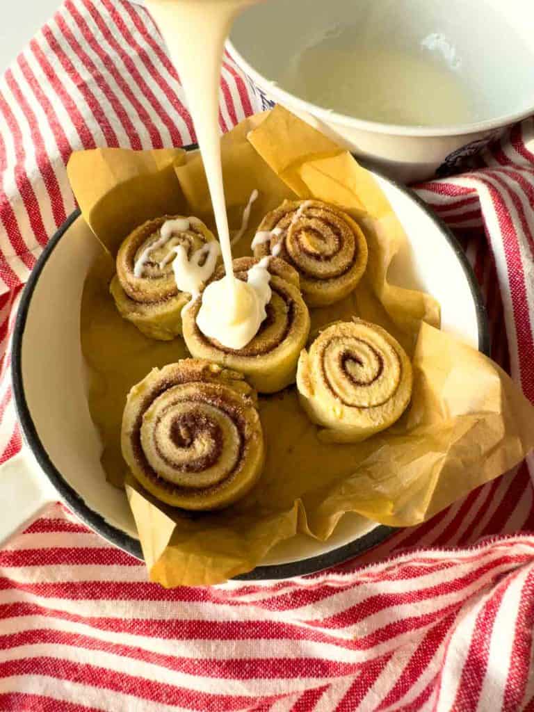 Icing drizzled over cinnamon swirl cookies.