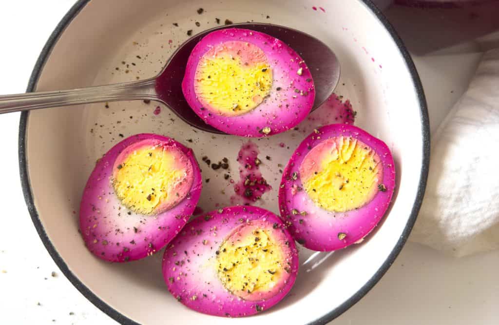 Pink pickled eggs in half.