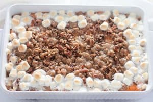 Sweet potato casserole topped with pecan streusel and toasted marshmallows around the edges.