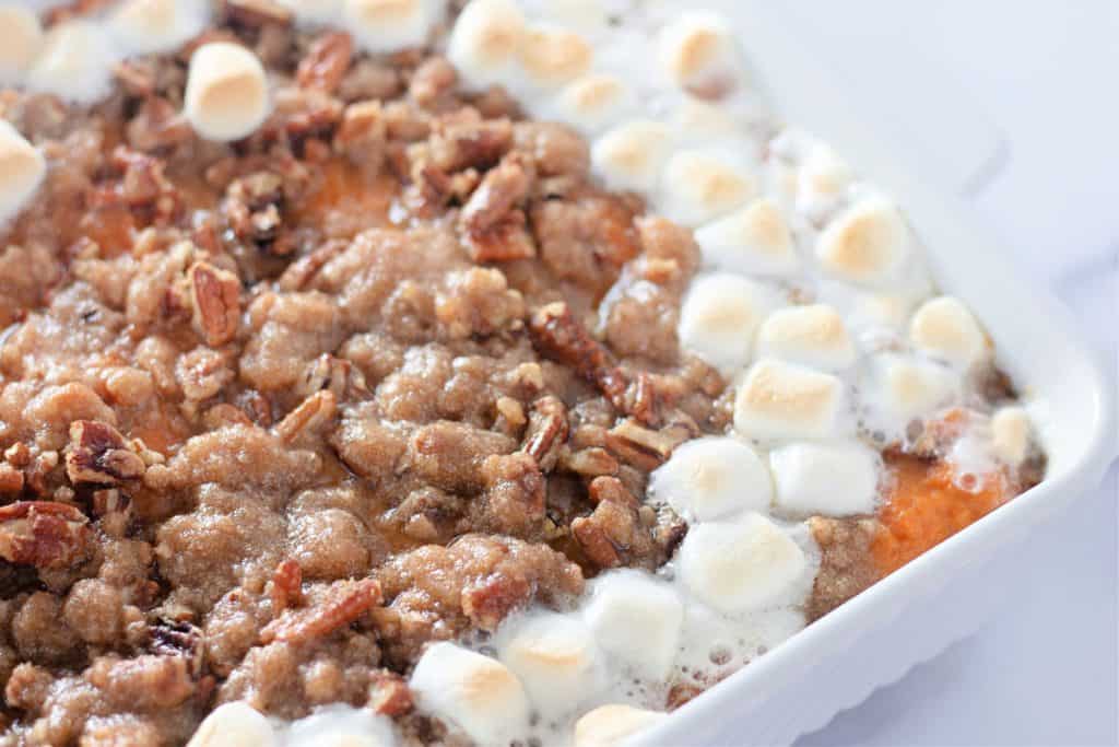 Sweet potato casserole topped with pecan streusel and toasted marshmallows around the edges.