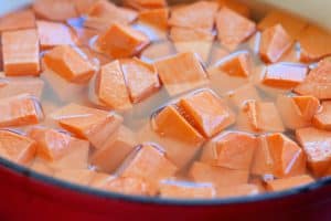 Cubed sweet potatoes in water, ready for cooking.
