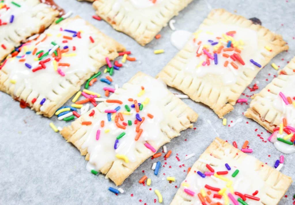 Mini homemade Pop-Tarts with icing and sprinkles.