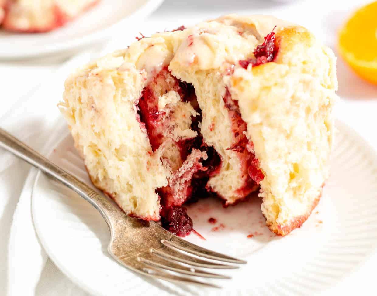 A sliced orange cranberry roll. 