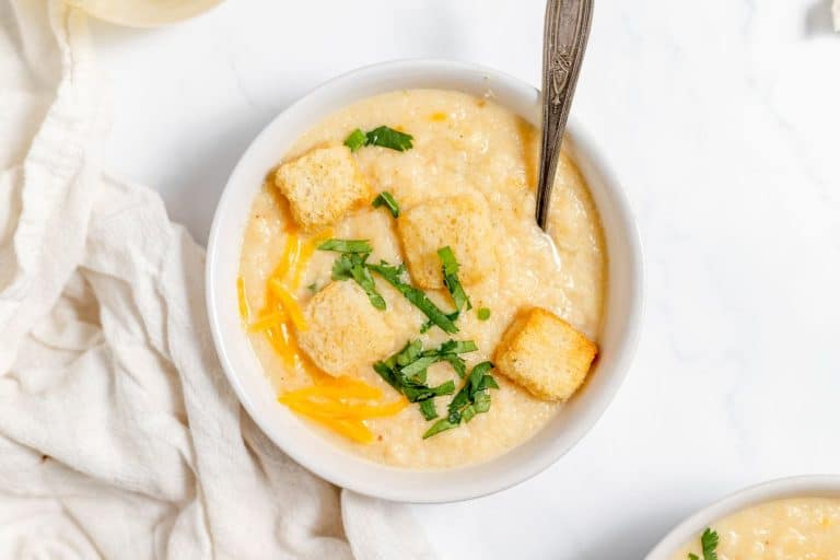 A bowl of cheesy roasted cauliflower soup.