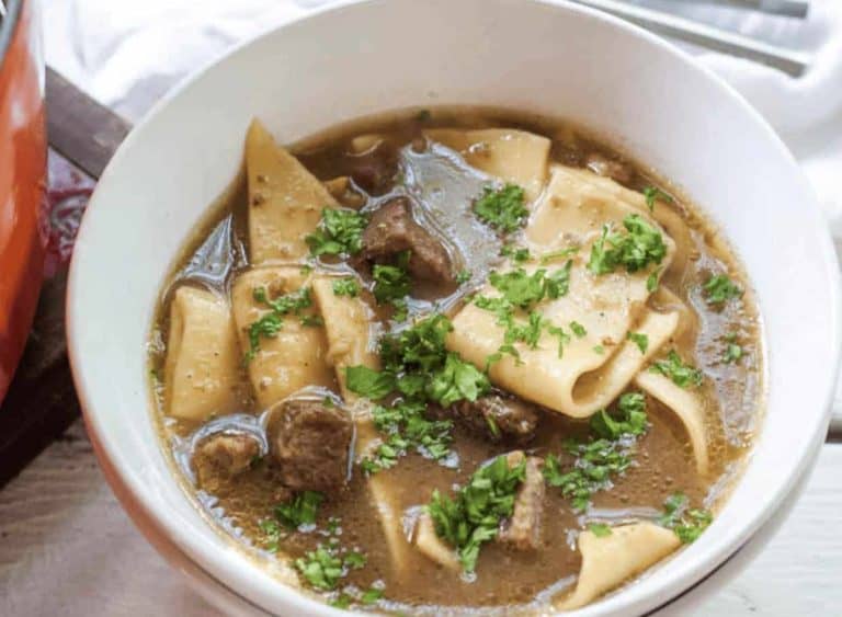 A bowl of beef and noodle soup.