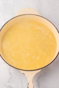 Creamy sauce for turkey tetrazzini in a skillet.