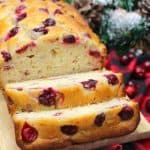 Cranberry Orange Bread sliced on a cutting board.