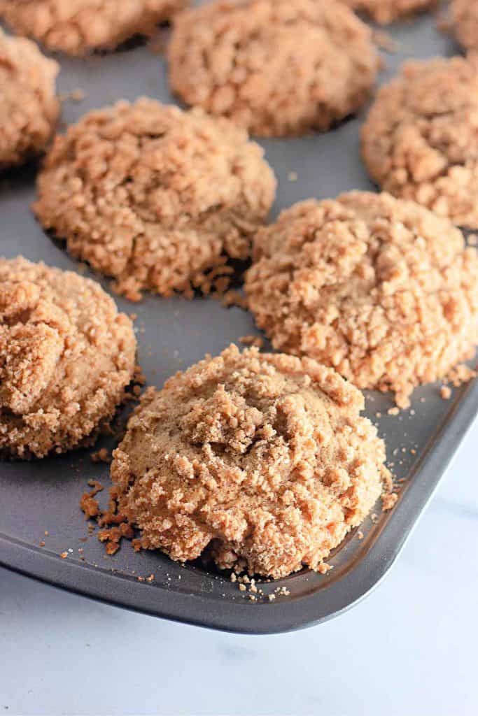 Baked Streusel Topped Apple Muffins in the muffin pan.