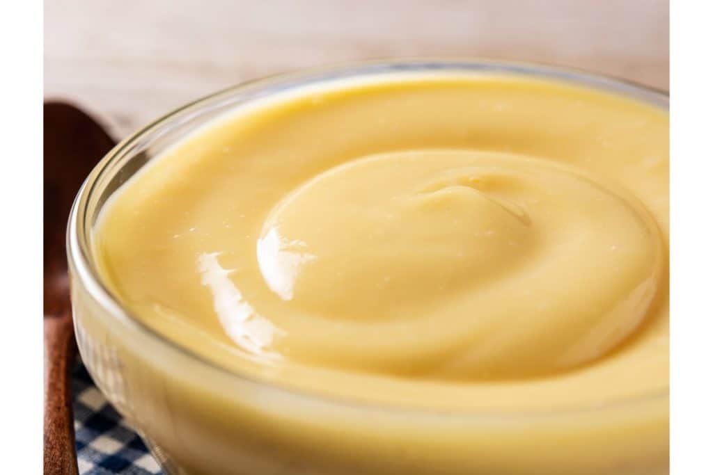 A bowl of smooth custard filling for the Boston Cream Pie Cake.