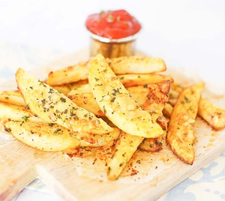 A serving of baked potato wedges with herbs and cheese.