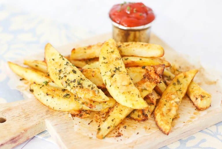 Golden-brown potato wedges with herbs.