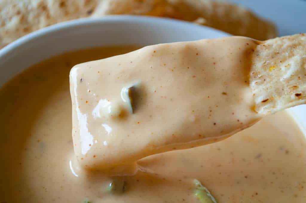 Chip dipped in the queso bowl.
