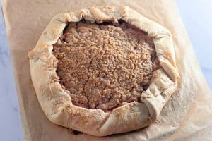Baked apple crumb galette with golden, flaky crust and crispy topping.
