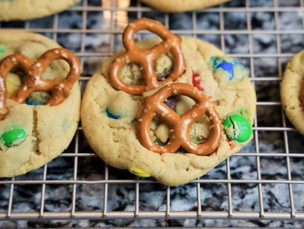 Close-up of an M&M's pretzel cookie with golden edges.