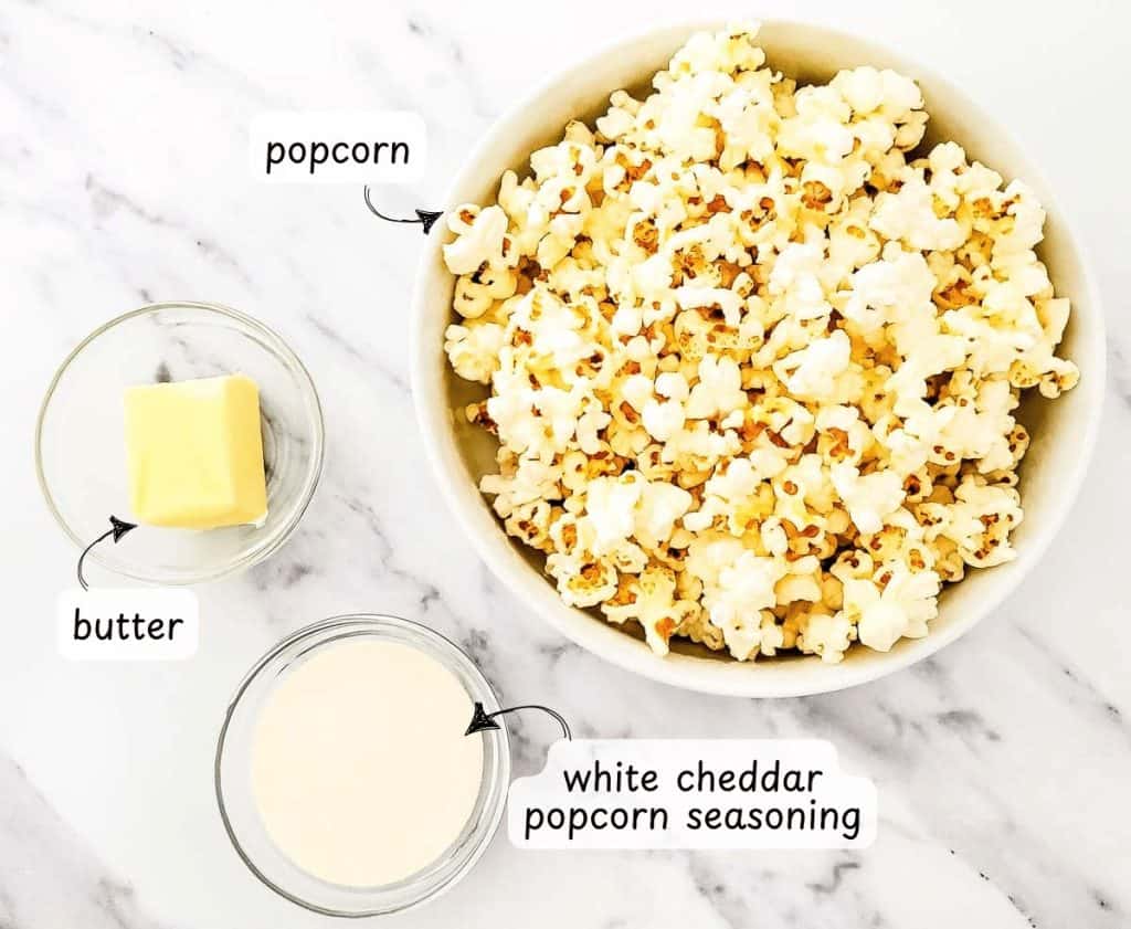 Labeled image showing popcorn, butter, and white cheddar popcorn seasoning in separate bowls.