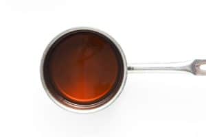 Pot of amber-colored dandelion syrup.