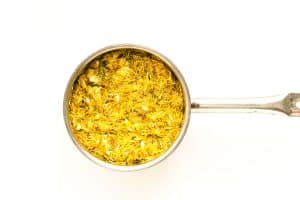 Saucepan filled with dandelion petals.