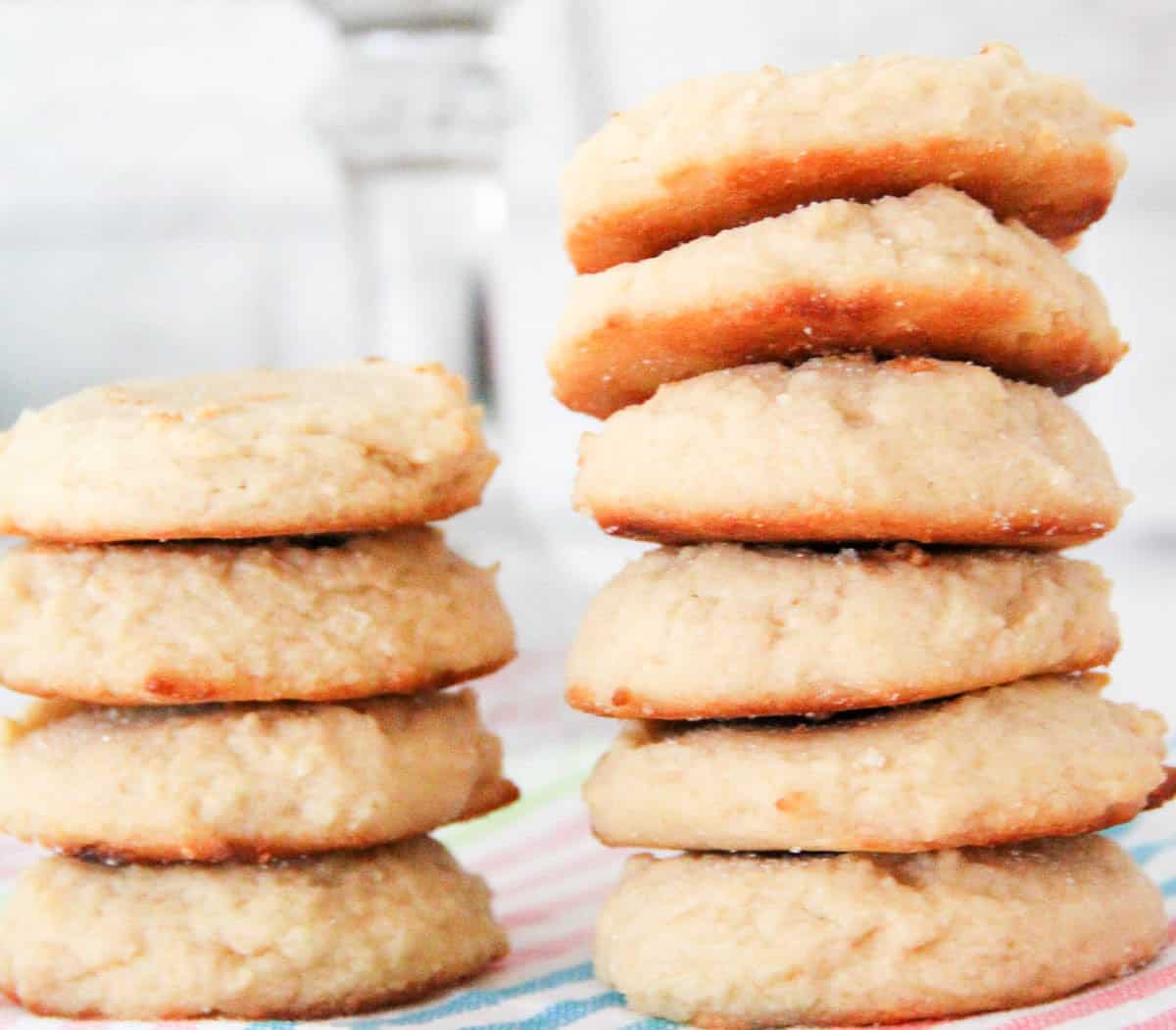 A stack of cookies on a striped linen.