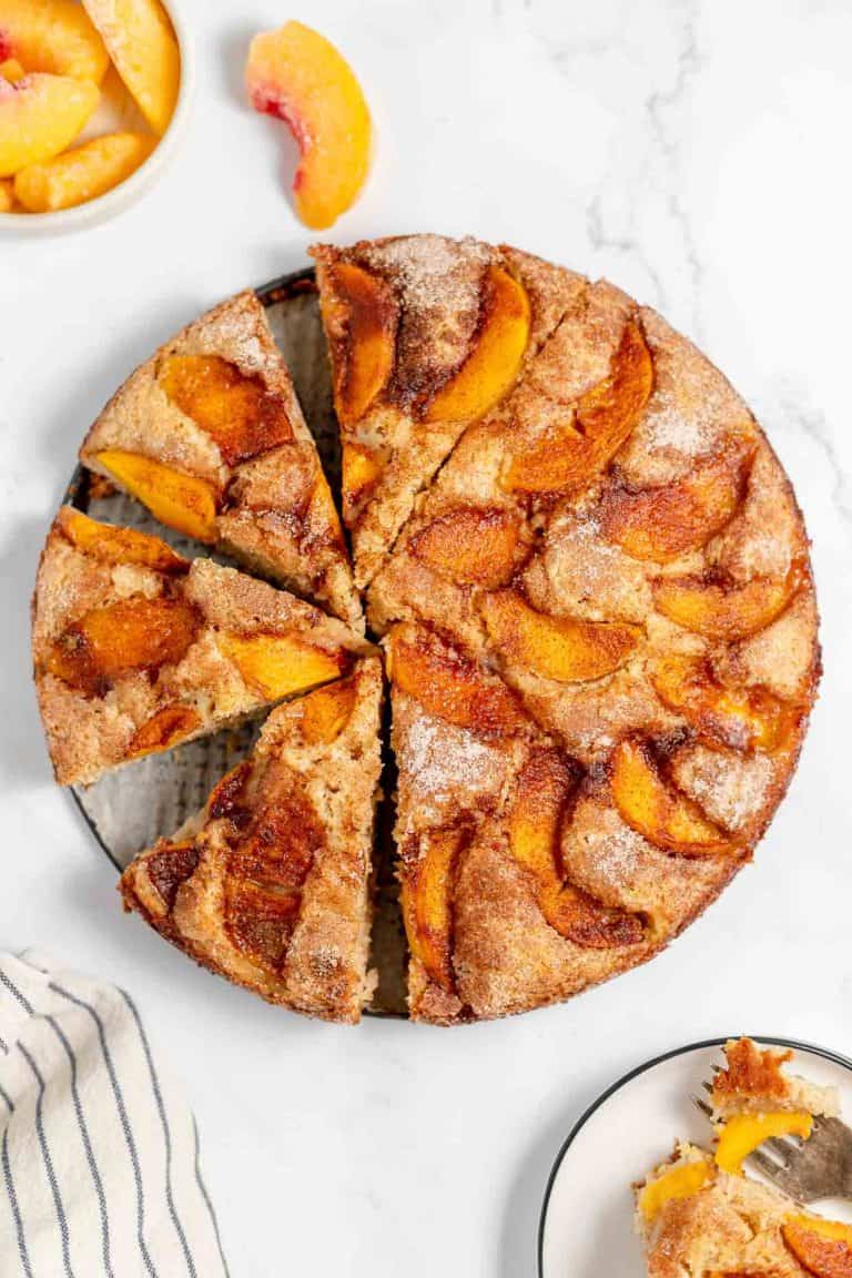 A cake with peaches on top.