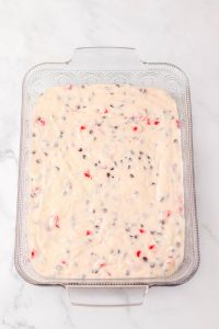 Glass baking dish filled with unbaked cake batter.