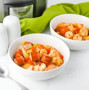 Bright top-down view of jambalaya in a bowl with sausage, chicken, and shrimp.