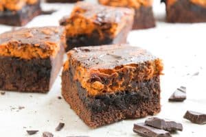 Close-up of pumpkin cheesecake brownie square with chocolate chunks.