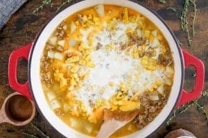 Chowder simmering with cream added to the pot.