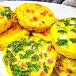 Close-up of mini omelets stacked on a plate.