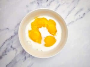 Milk and eggs in a large bowl.