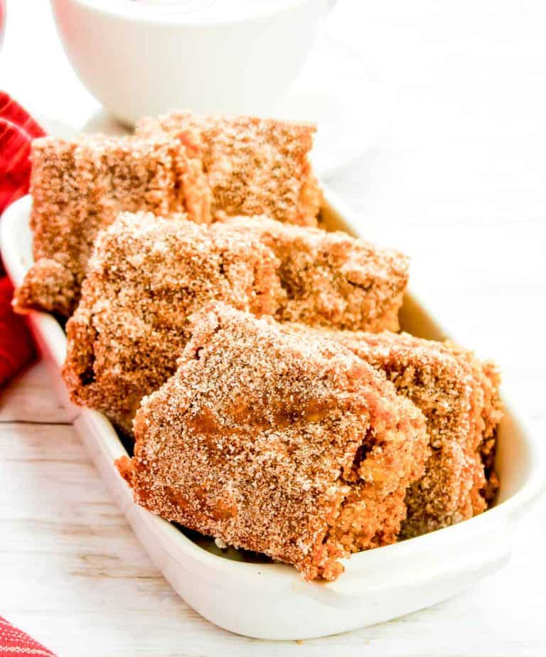 Bright close-up of sugar-coated apple cider blondies in a dish.