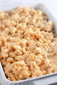 Casserole dish of plain macaroni in cheese sauce.