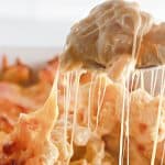 Close-up of spoonful of cheesy macaroni and cheese.