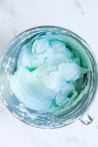 Light green meringue mixture ready in a mixing bowl.