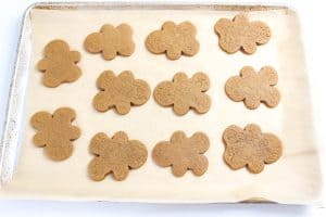 Baked gingerbread cookies cooling on parchment paper.