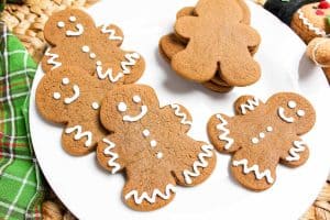 Close-up of smiling gingerbread cookies decorated with white icing.