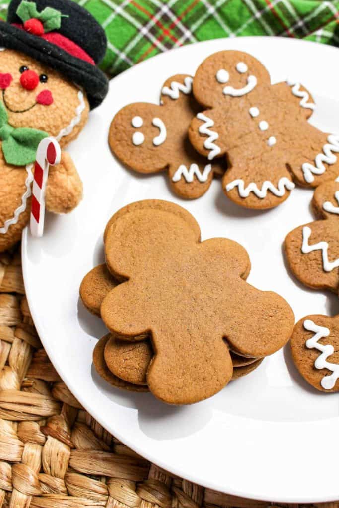 Overhead view of gingerbread cookies with a mix of decorated and plain ones.