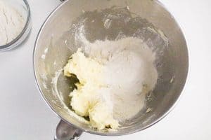 Flour added to the creamed mixture in the bowl.