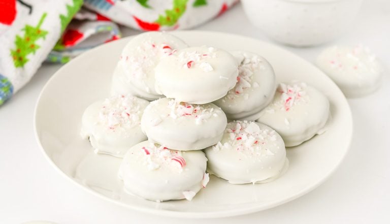 Close-up of stacked Peppermint Bark Oreos on a white plate.