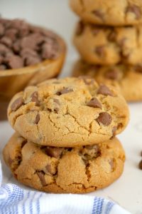 Stack of thick chocolate chip cookies with chocolate chips throughout.