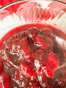 A spoonful of thick brown sugar cranberry sauce.