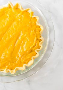 Butterscotch filling poured into a pie crust.